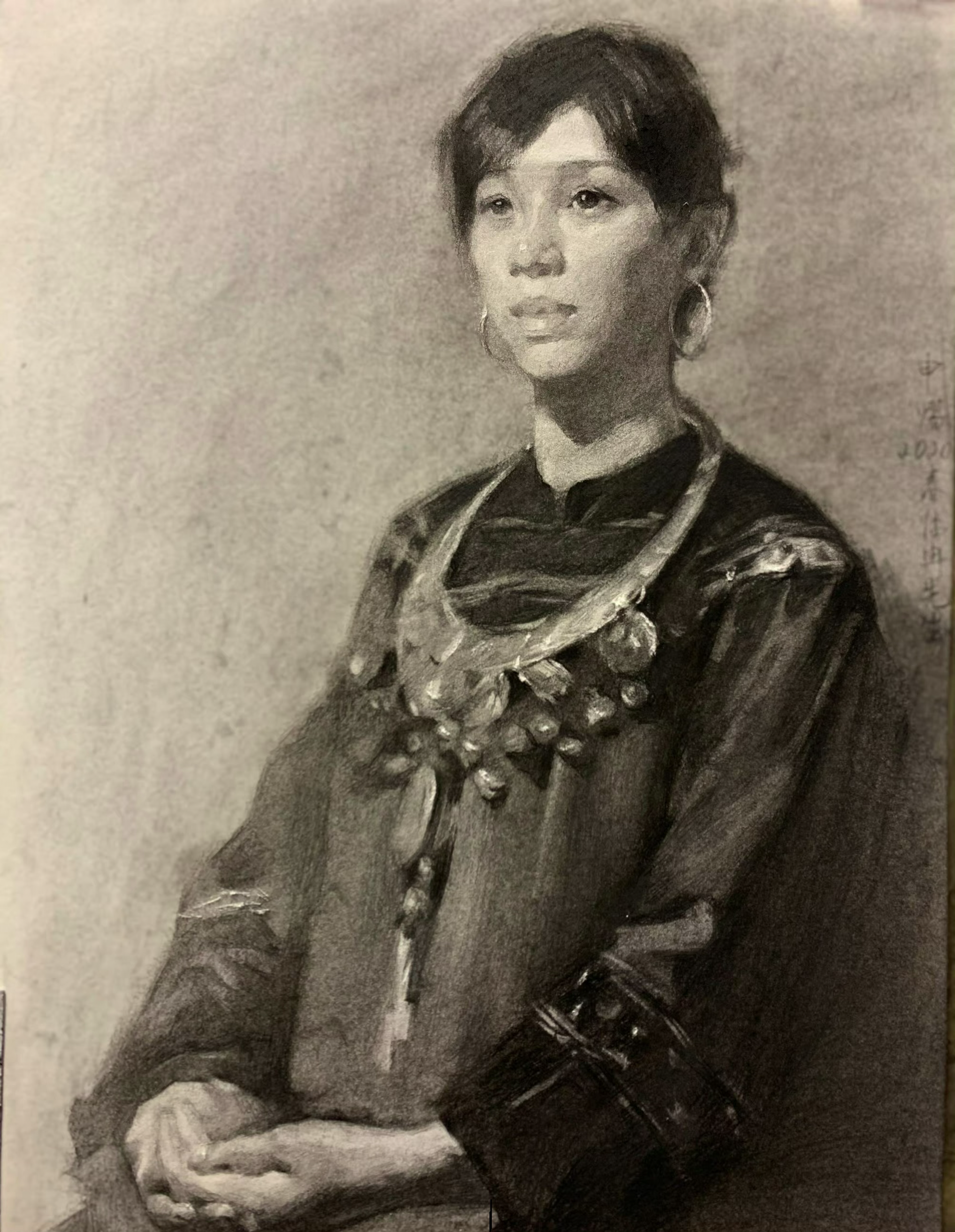 Seated portrait in charcoal